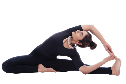 Young lady performing yoga for health and fitness.Indian lady performing yoga