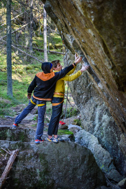 istock Young athlets exploring rock climbing routes in scandinavian forest. 1135549845