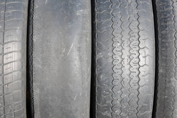 istock worn out bald old car tire close-up 1135550953