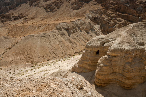 Qumran Cave with the dead sea Qumran Cave 4, site of the discovery of the Dead Sea Scrolls in Qumran, Israel near the Dead Sea dead sea scrolls stock pictures, royalty-free photos & images