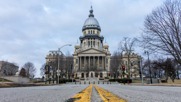 Road leading toward the state capitol building in Springfield, Illinois. Yellow lines and pot holes on the road leading up to the state capitol building in Springfield, Illinois. springfield illinois stock pictures, royalty-free photos & images