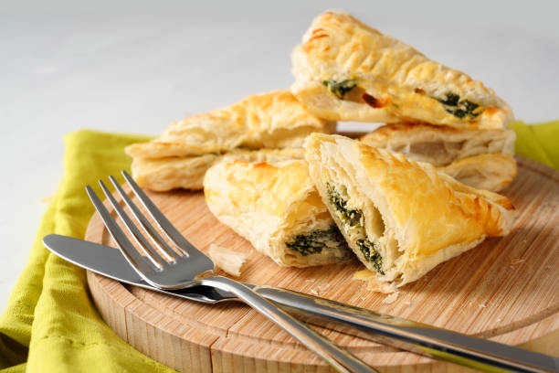istock puff pastry filled with spinach and ricotta on a wooden kitchen board 1135552273