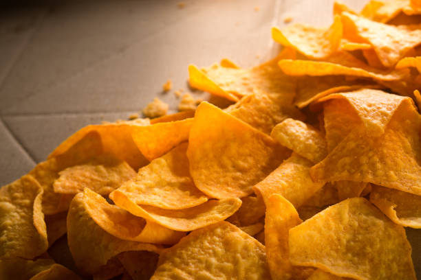 istock Golden nachos chips on a craft paper box 1135553565