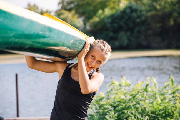 istock Girl carries a kayak 1135554446