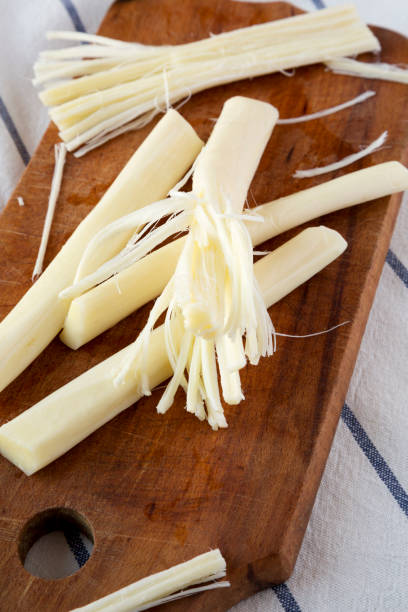 istock String cheese on rustic wooden board, low angle view. Healthy snack. Close-up. 1135555329