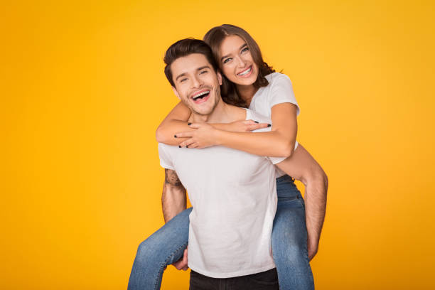 istock Lovely couple having fun, man piggybacking his girlfriend 1135555432