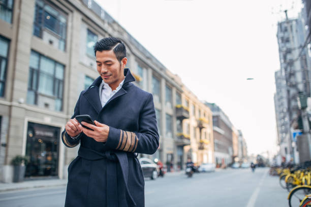 istock Man with mobile phone outdoors 1135555964