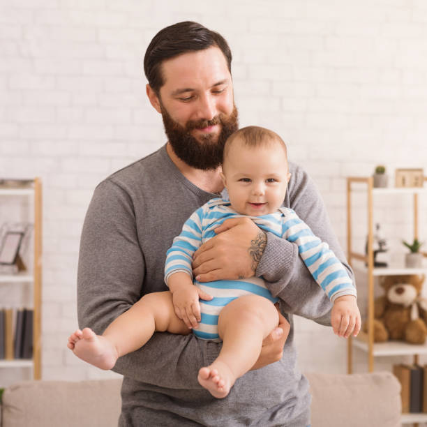 istock Loving father embracing his cute baby son 1135558872