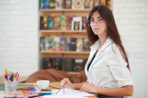 istock Woman in spectacles posing, holding compasses. 1135560154