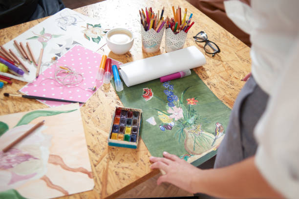 istock Table with painter's supplies and pictures. 1135560155