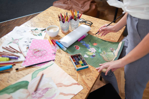 istock Painter standing near table with picture. 1135560156