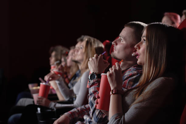 istock Group watching intriguing movie in cinema. 1135560247