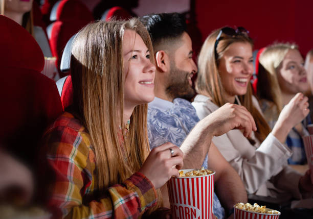 istock Smiling beautiful woman watching movie. 1135560256
