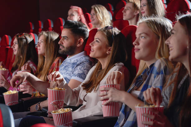 istock Group of female watching comedy in cinema. 1135560273