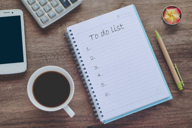 istock To Do List text on book note with cup of coffee, pen and smartphone. 1135566598