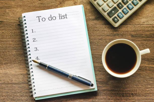 istock To Do List text on book note with cup of coffee, pen and smartphone. 1135566611