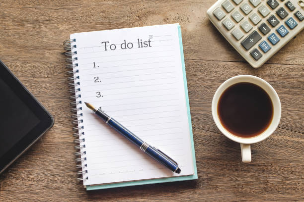 istock To Do List text on book note with cup of coffee, pen and smartphone. 1135566614