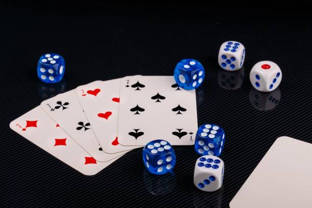 istock blue and white dices and cards on black glossy background 1135568539