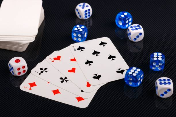 istock blue and white dices and cards on black glossy background 1135568696