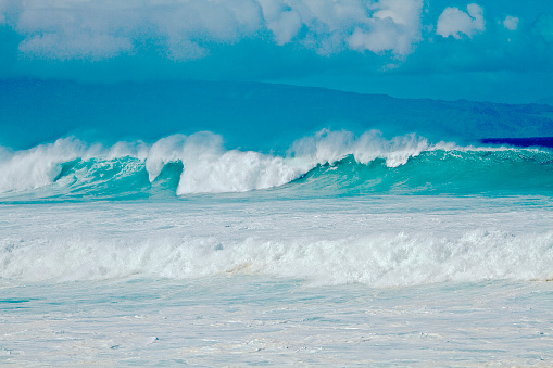 Big Waves with mountains, cloudscape