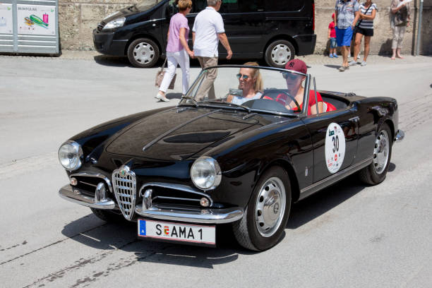 Classic Alfa Romeo at the Gaisberg race in Salzburg, Austria Salzburg / Austria - May 2018. Alfa Romeo Giulietta Spider arriving at the finish in the center of Salzburg during the historic Gaisberg Classic Race. The Gaisberg road became the venue of a car and motorcycle hillclimb race between 1929 and 1969, which was part of the European Hillclimb Championship. gaisberg stock pictures, royalty-free photos & images