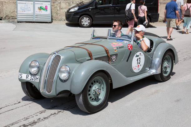 Classic BMW at the Gaisberg race in Salzburg, Austria Salzburg / Austria - May 2018. Beautiful 1937 grey BMW 328 Roadster arriving at the finish in the center of Salzburg during the historic Gaisberg Classic Race. The Gaisberg road became the venue of a car and motorcycle hillclimb race between 1929 and 1969, which was part of the European Hillclimb Championship. gaisberg stock pictures, royalty-free photos & images