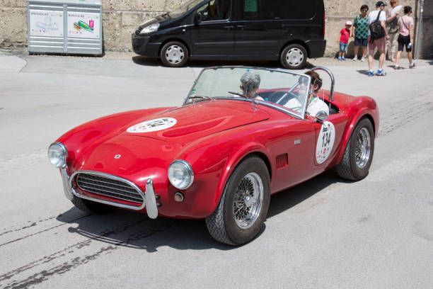 Classic Cobra AC at the Gaisberg race in Salzburg, Austria Salzburg / Austria - May 2018. Beautiful 1964 red Cobra AC 289 arriving at the finish in the center of Salzburg during the historic Gaisberg Classic Race. The Gaisberg road became the venue of a car and motorcycle hillclimb race between 1929 and 1969, which was part of the European Hillclimb Championship. gaisberg stock pictures, royalty-free photos & images