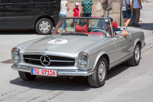 Classic Mercedes Pagode at the Gaisberg race in Salzburg, Austria Salzburg / Austria - May 2018. Beautiful late sixties Mercedes Pagode arriving at the finish in the center of Salzburg during the historic Gaisberg Classic Race. The Gaisberg road became the venue of a car and motorcycle hillclimb race between 1929 and 1969, which was part of the European Hillclimb Championship. gaisberg stock pictures, royalty-free photos & images