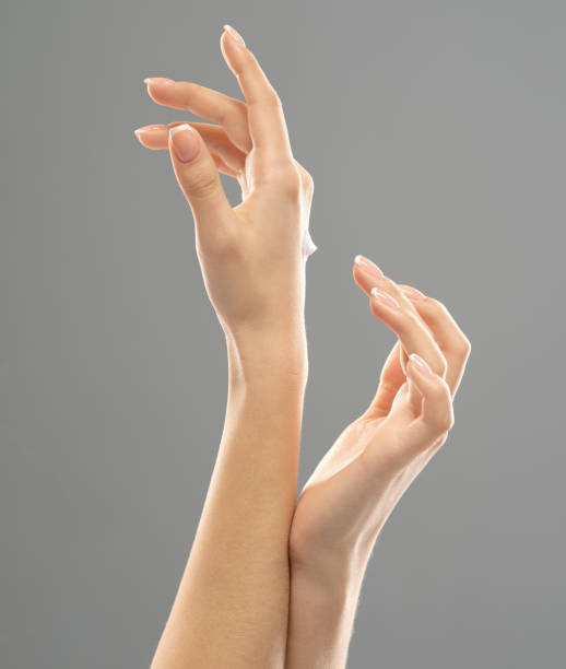 istock Woman applies a cosmetic moisturizer on her hands. 1135571809