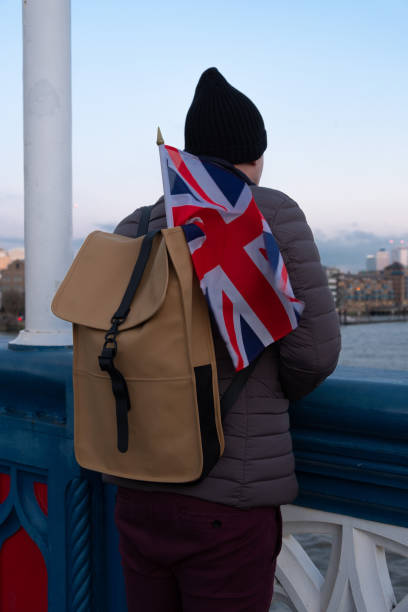 istock Handsome man standing on a bridge with the English flag 1135572067