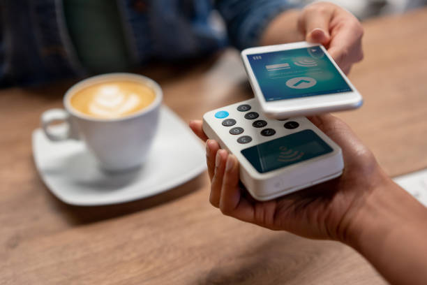 istock Unrecognizable waitress holding contacless payment and customer paying with mobile apploication 1135573720