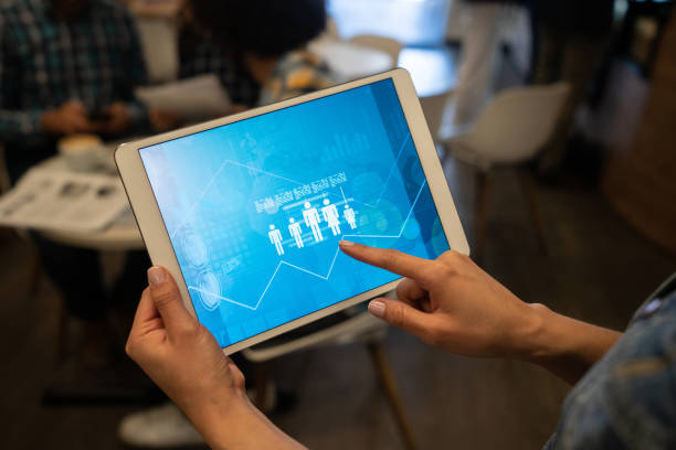istock Unrecognizable woman holding a tablet with inphographics displaying on screen 1135573728