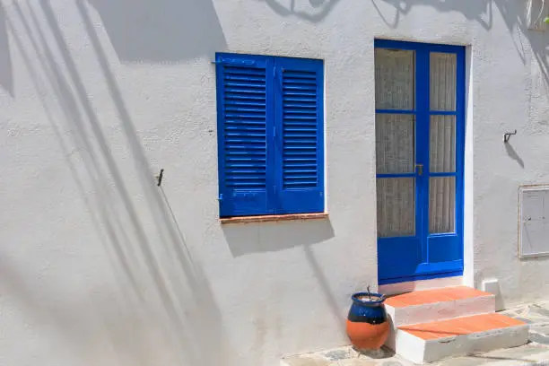 Typical white Mediterranean house, with blue door, in the small fishing village of cadaques, typical Mediterranean village on the Costa Brava of Spain