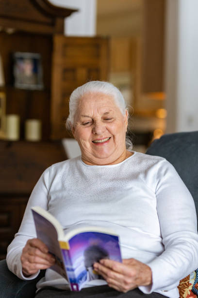 istock Old lady reading a book indoors 1135575108