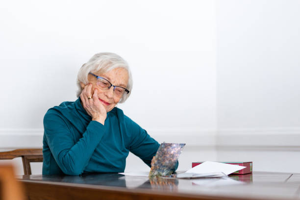 Old lady writing a card Old lady writing a card senior birthday card stock pictures, royalty-free photos & images