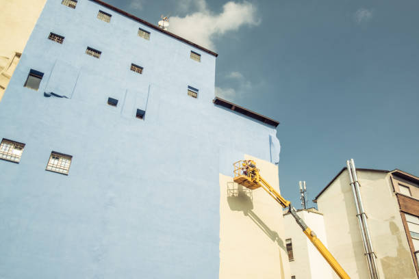 istock A worker painting the wall of a building 1135575570