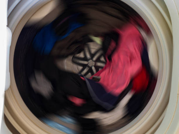 istock Top view of a washing machine drum during spinning clothes. Top loading washing machine washes laundry. 1135576671