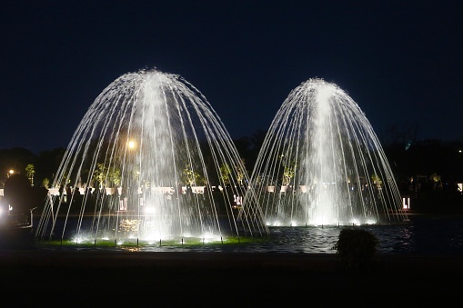 India Gate, New Delhi, India - March 10, 2019: Night-time illuminated view of the India Gate fountains.