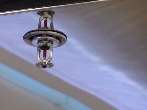 istock fire sprinkler install on reflective stainless sheet on high ceiling 1135577544
