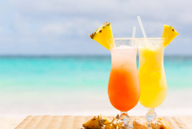 istock Two tropical fresh juices on white sandy beach 1135578620