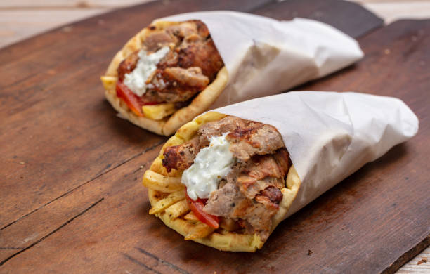 gyro pita, shawarma, take away, street food. traditional greek turkish, meat food on wooden table - opa! souvlaki of greece imagens e fotografias de stock