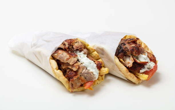 Gyro pita, shawarma, take away, street food. Traditional greek turkish, meat food isolated on white background Gyro pita, shawarma, take away, street food. Two pita bread wraps with meat, traditional greek turkish food isolated on white background shawarma stock pictures, royalty-free photos & images