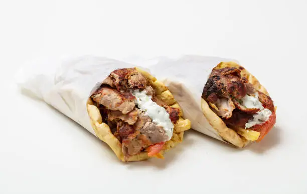 Gyro pita, shawarma, take away, street food. Two pita bread wraps with meat, traditional greek turkish food isolated on white background