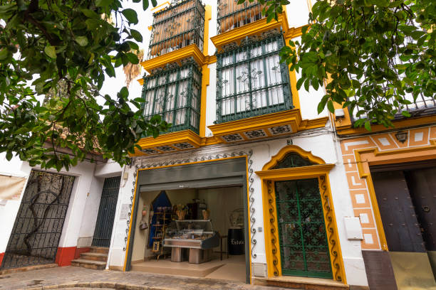 Seville, Spain - October 23, 2018: Seville's old Jewish quarter is a complex network of little streets with a typical Andalusian flavor. Image taken from Plaza de Doña Elvira.