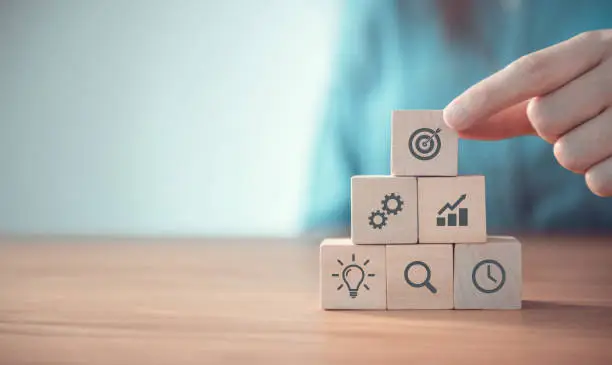 Photo of Businessman hand arranging wood block with icon business strategy and Action plan, copy space.