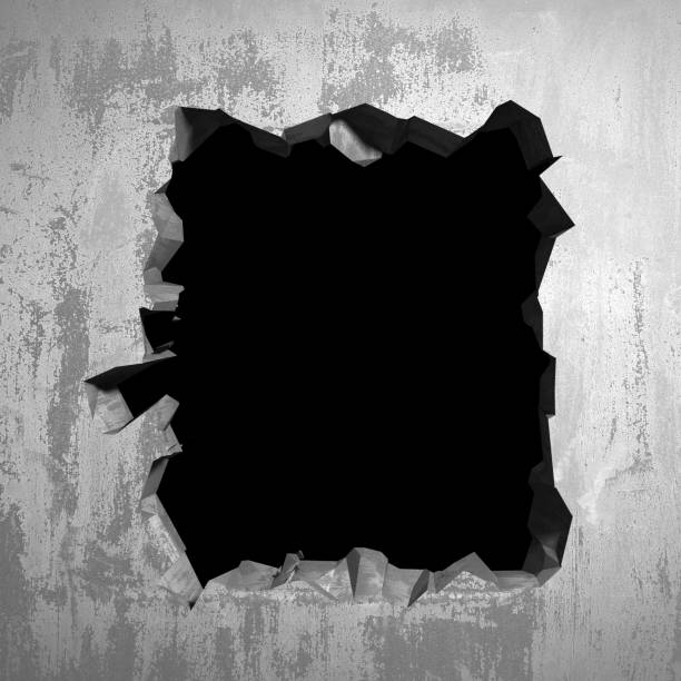 istock Dark cracked broken hole in concrete wall 1135585980