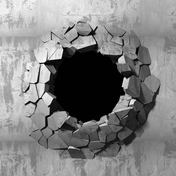 istock Dark cracked broken hole in concrete wall 1135586062