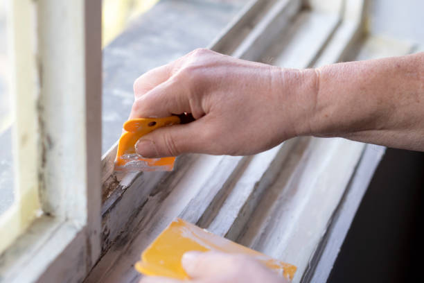 istock Senior man sanding old window frame in his apartment 1135586610