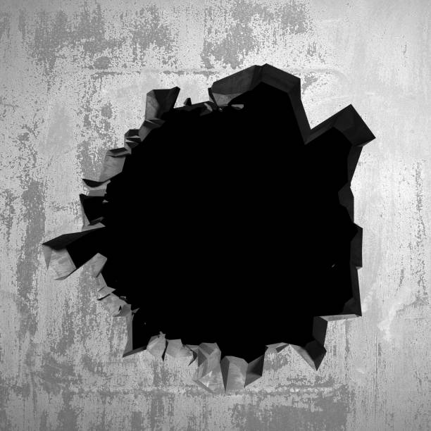 istock Dark cracked broken hole in concrete wall 1135586616