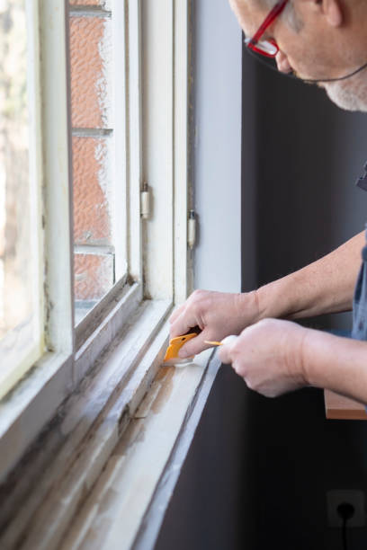 istock Senior man sanding old window frame in his apartment 1135586692